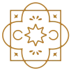 A geometric, ornate golden emblem featuring a central floral motif, circular rings, and four-lobed symmetrical design ending with a decorative border.